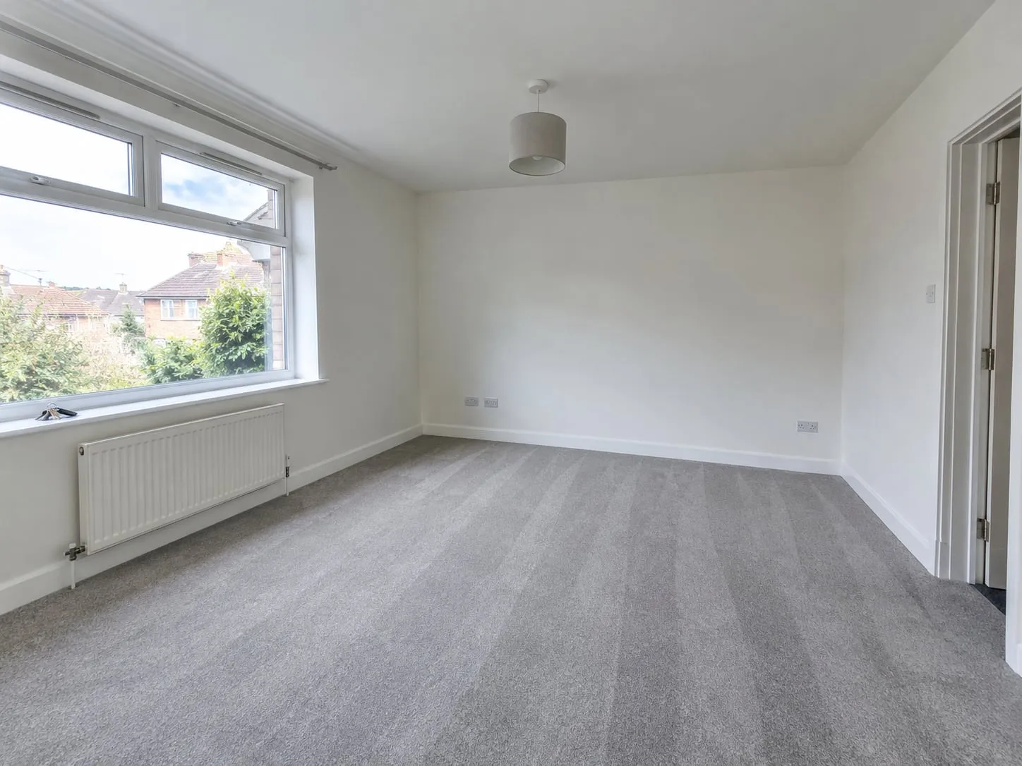 An empty flat after an end of tenancy clean, with fresh vacuum lines on the carpet